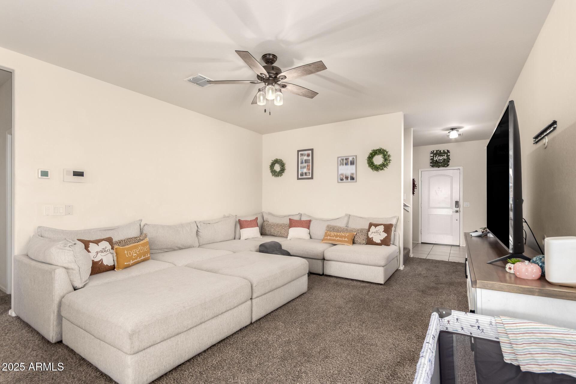 30879 West Picadilly Road Buckeye, AZ 85396 - Photo 10 of 34 a living room with furniture and a flat screen tv