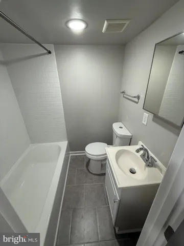 a bathroom with a sink a toilet and a bathtub