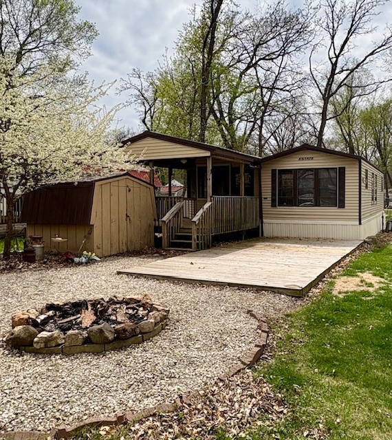 5-101 Woodhaven Sublette, IL 61367 - Photo 1 of 23 a view of a house with a yard fire pit and a large tree