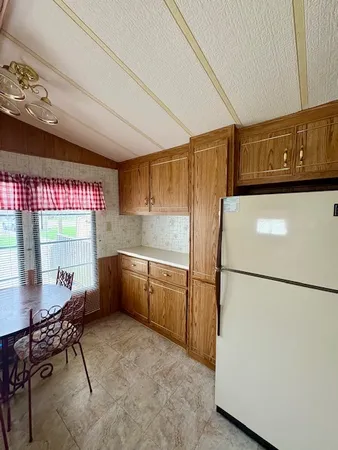a kitchen with a refrigerator and a table