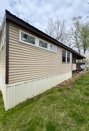 a side view of a house with a yard