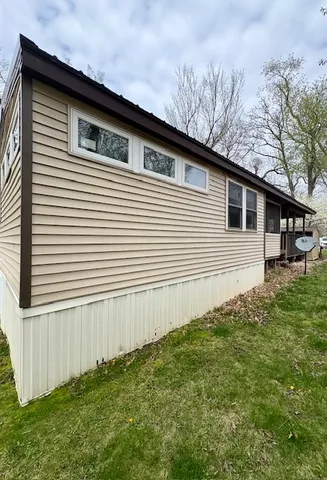 a side view of a house with a yard