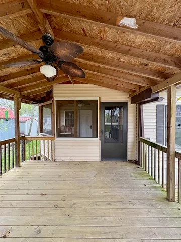a view of staircase with a ceiling fan