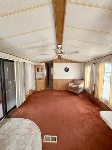 a view of a bedroom with furniture and windows