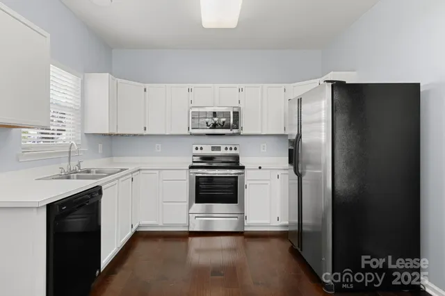 a kitchen with a refrigerator stove and sink