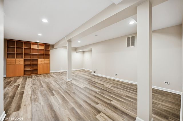 a view of empty room with wooden floor and closet