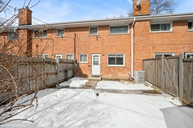 a view of a house with a wooden fence