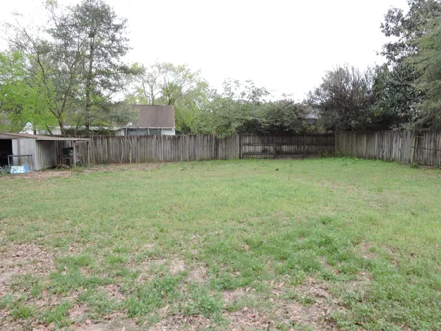 a view of a backyard with a small cabin