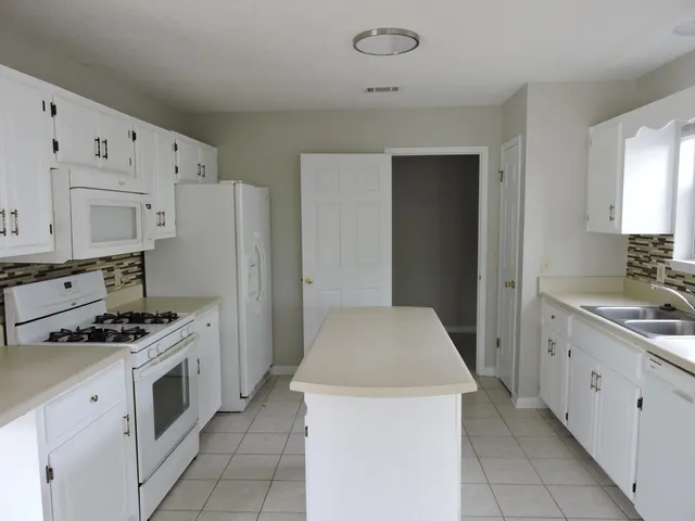 a kitchen with cabinets and steel appliances