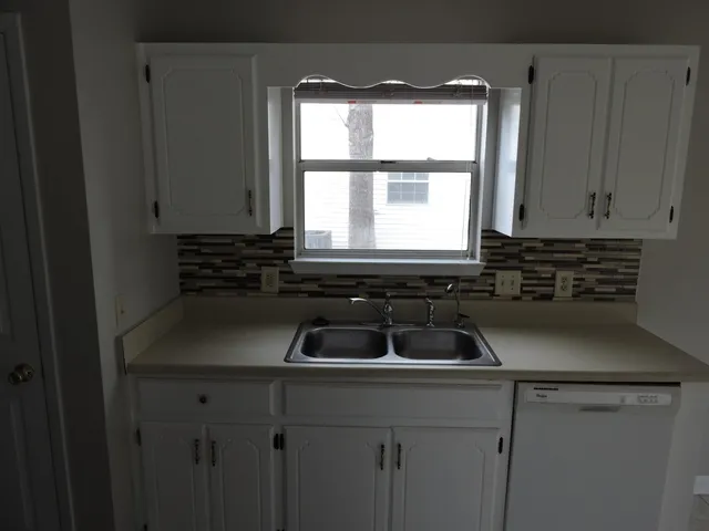 a kitchen that has a sink and a window