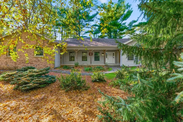 a front view of a house with a garden