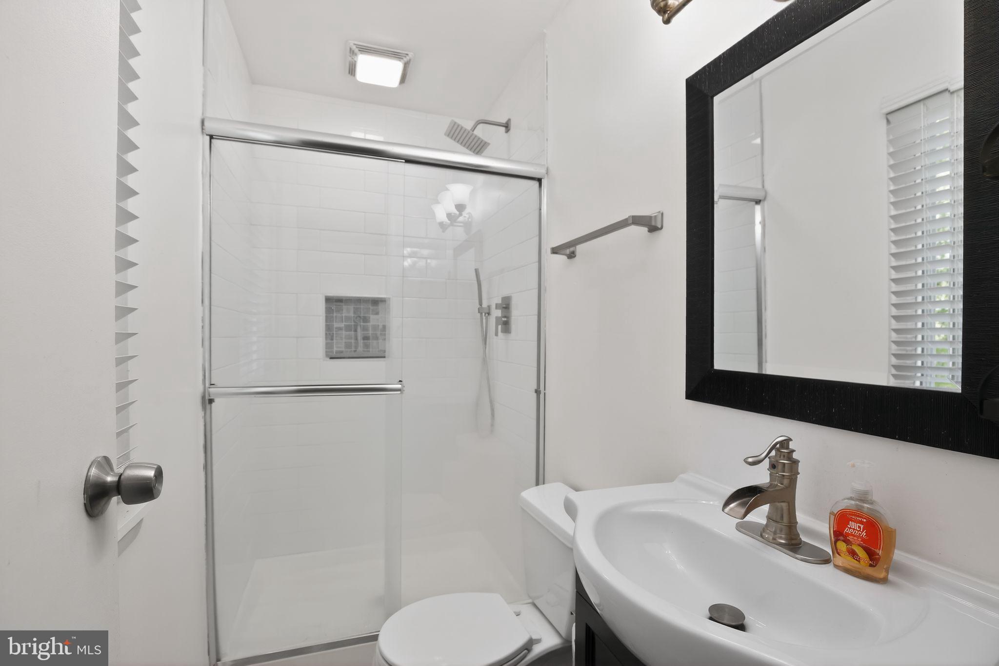 9276 Soaring Hill Road Columbia, MD 21045 - Photo 11 of 27 a bathroom with a sink a toilet and shower