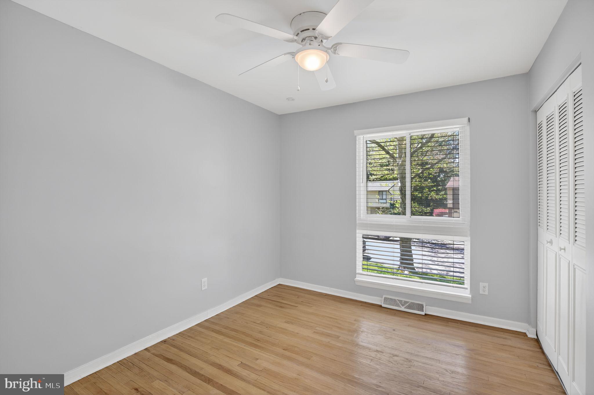 9276 Soaring Hill Road Columbia, MD 21045 - Photo 14 of 27 wooden floor in an empty room with a window