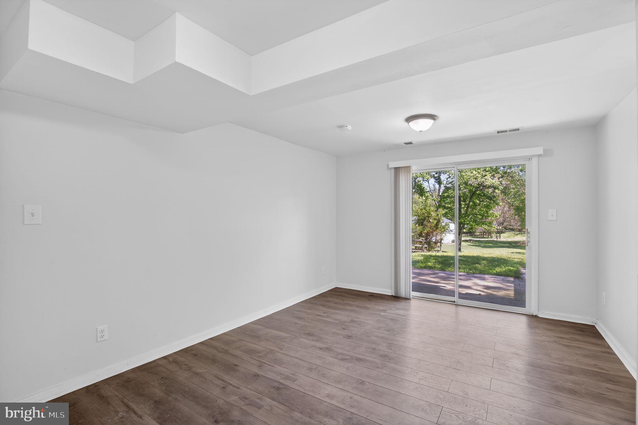 9276 Soaring Hill Road Columbia, MD 21045 - Photo 18 of 27 wooden floor in an empty room with a window