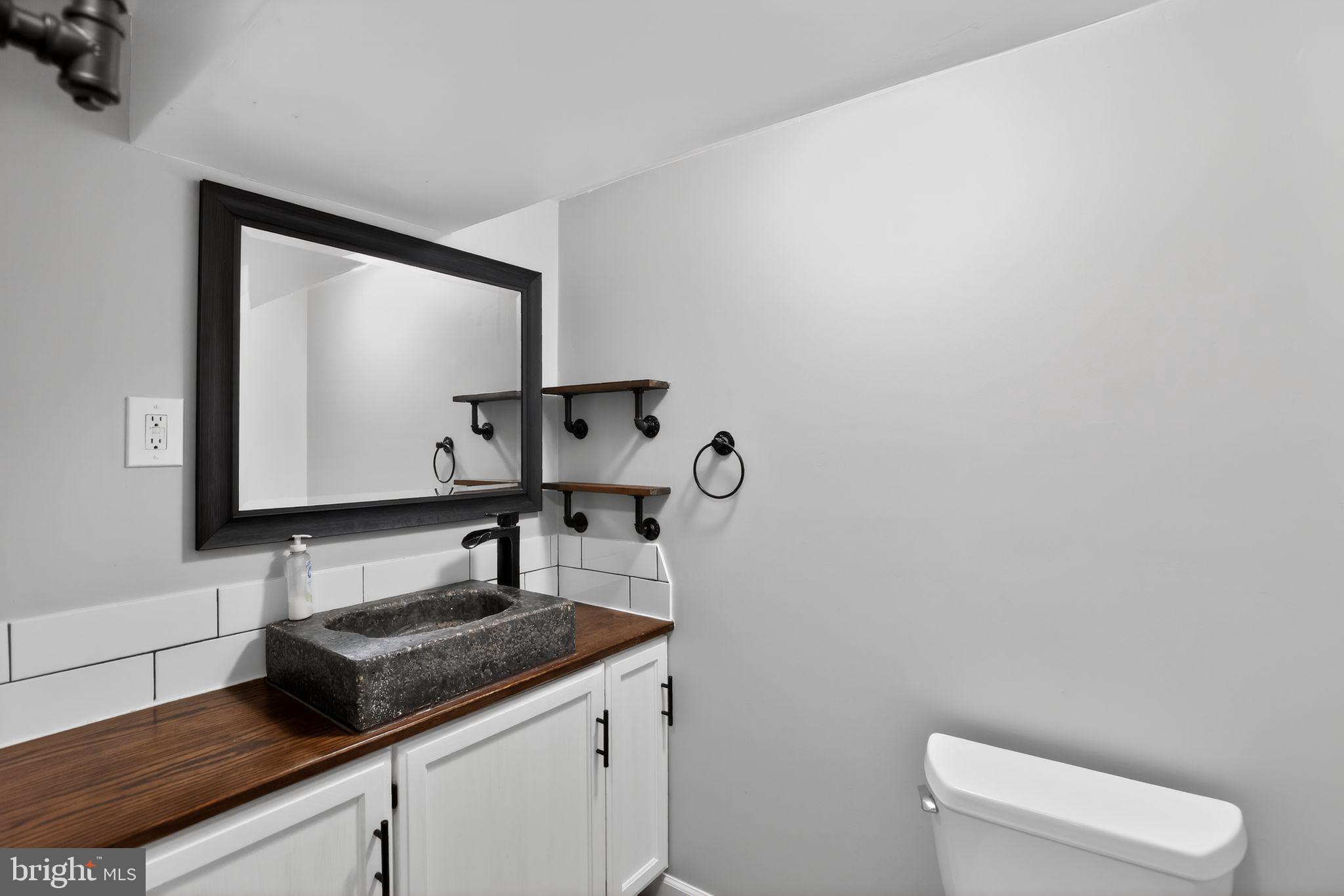 9276 Soaring Hill Road Columbia, MD 21045 - Photo 23 of 27 a bathroom with a toilet sink and mirror