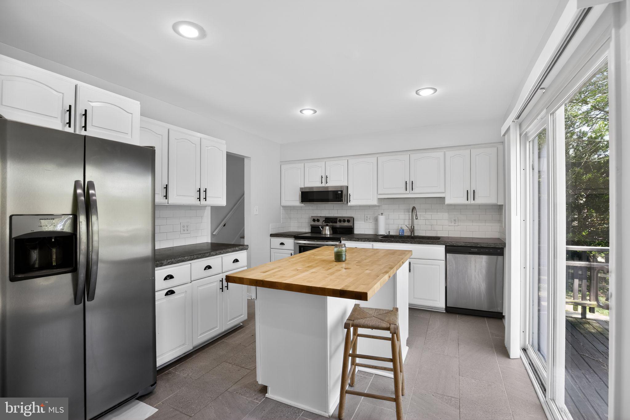 9276 Soaring Hill Road Columbia, MD 21045 - Photo 6 of 27 a kitchen with stainless steel appliances granite countertop a refrigerator sink and stove