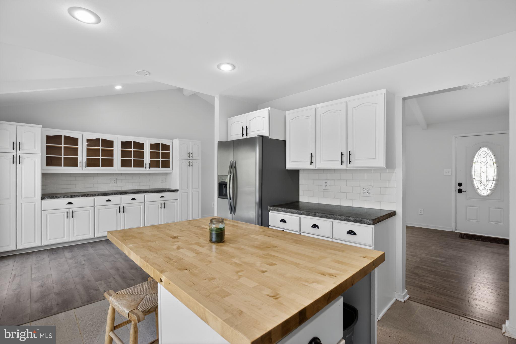 9276 Soaring Hill Road Columbia, MD 21045 - Photo 7 of 27 a kitchen with stainless steel appliances granite countertop a sink dishwasher and a refrigerator with wooden floor
