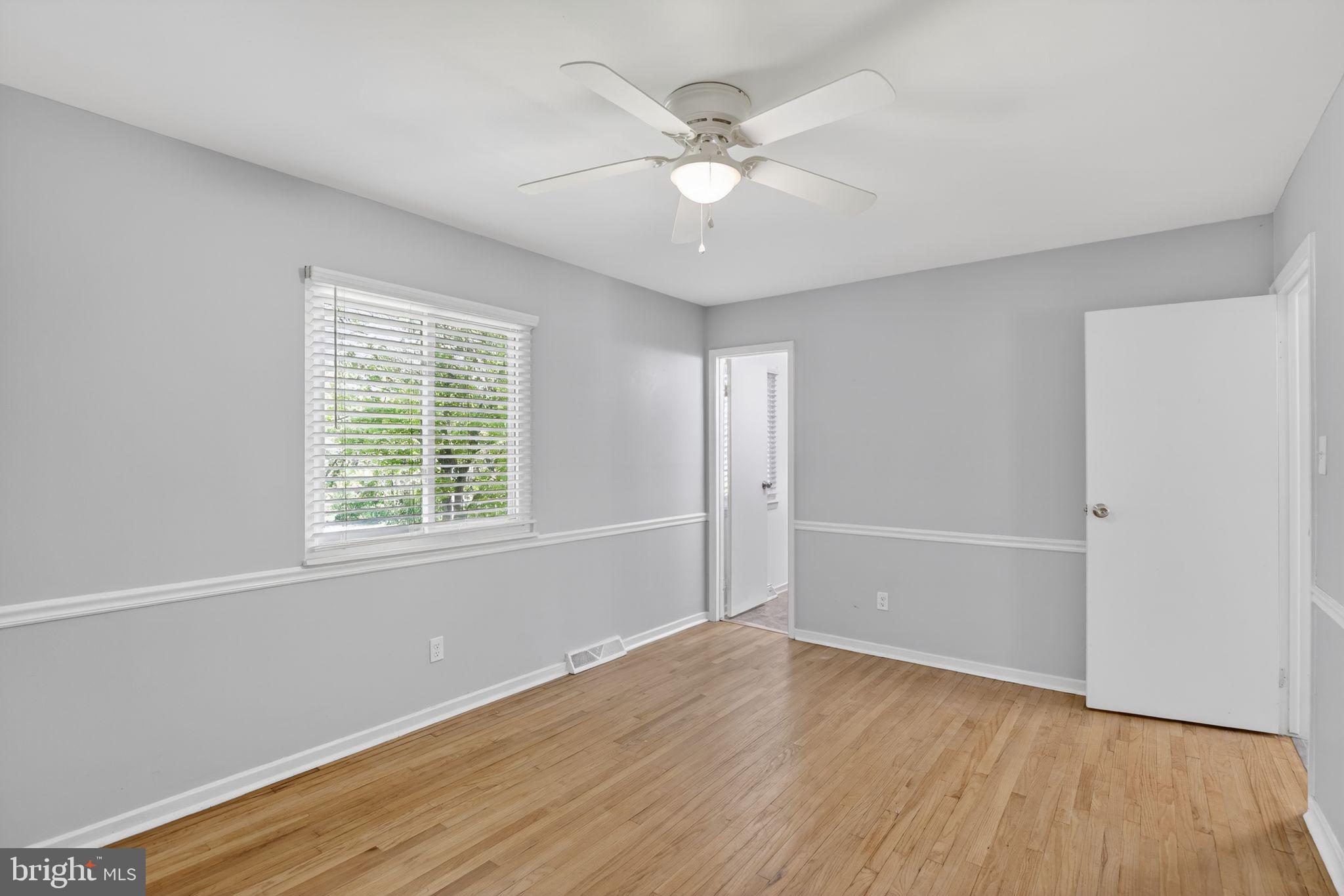 9276 Soaring Hill Road Columbia, MD 21045 - Photo 9 of 27 an empty room with wooden floor and windows