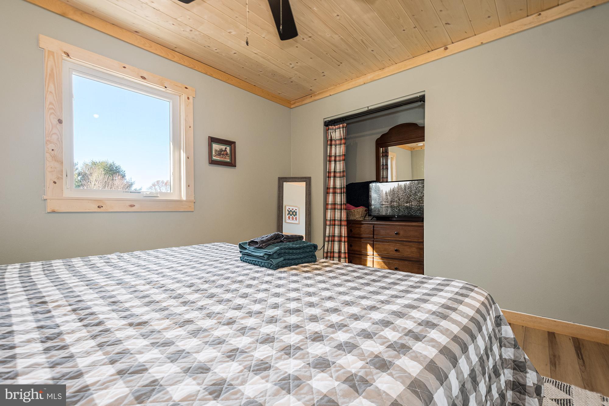 1015 Pysell Road McHenry, MD 21541 - Photo 14 of 56 a bedroom with a bed and a television