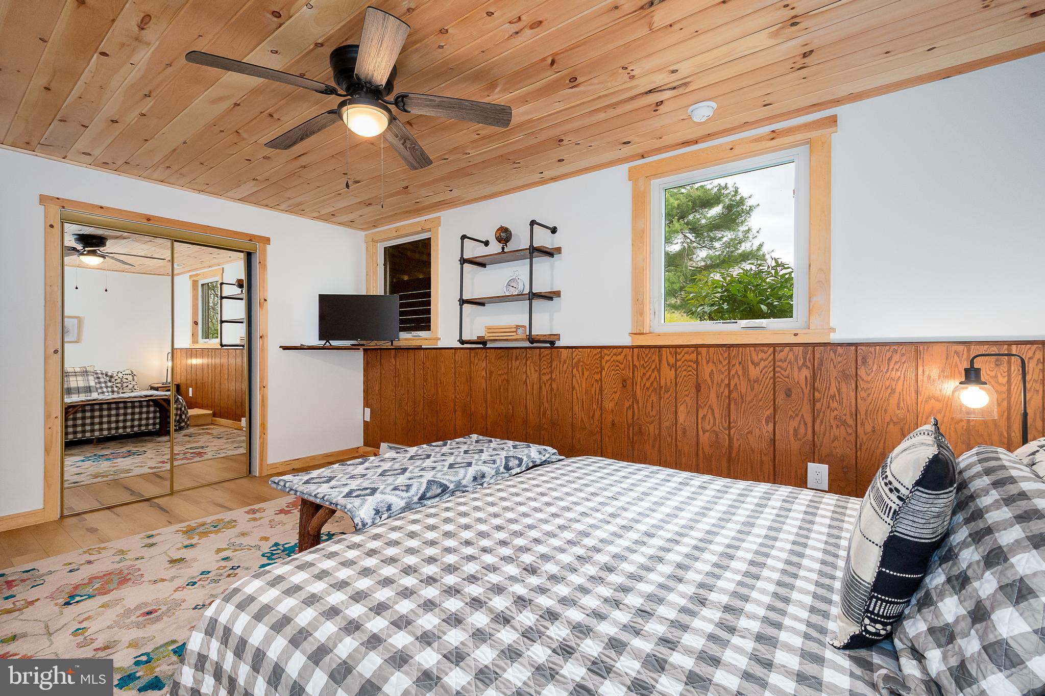 1015 Pysell Road McHenry, MD 21541 - Photo 30 of 56 a bedroom with a large bed and a window