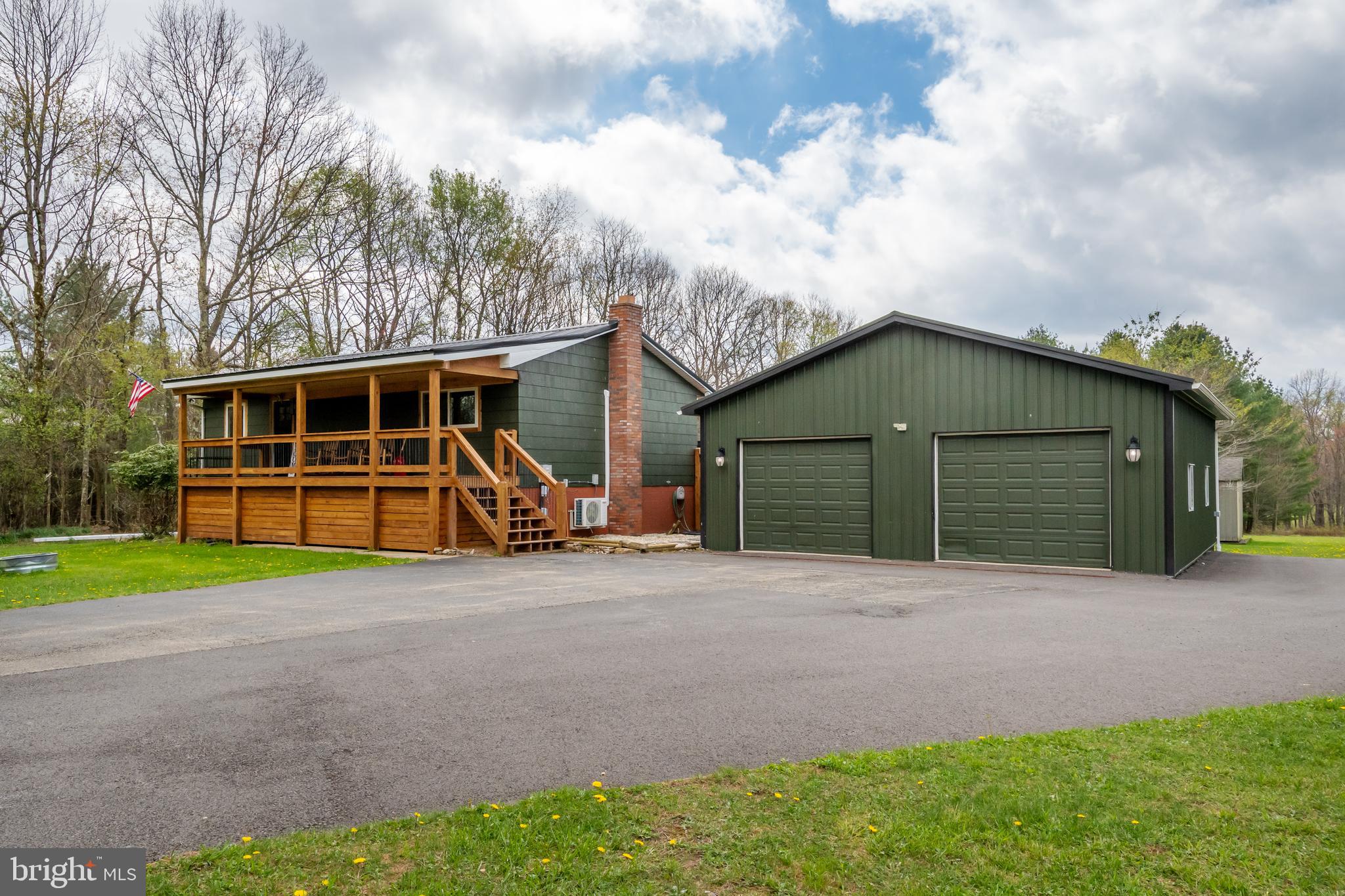 1015 Pysell Road McHenry, MD 21541 - Photo 55 of 56 a front view of a house with garden and trees