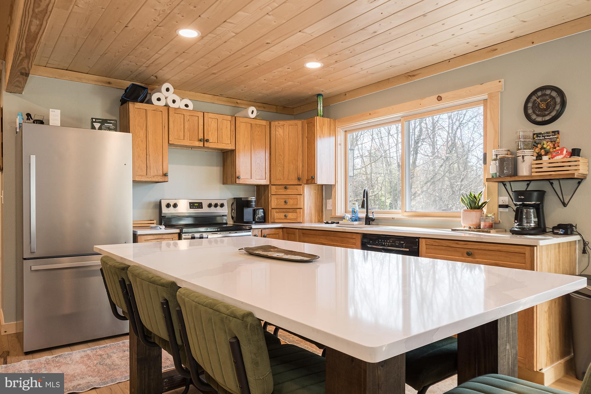 1015 Pysell Road McHenry, MD 21541 - Photo 7 of 56 a kitchen with a refrigerator a stove a sink and cabinets
