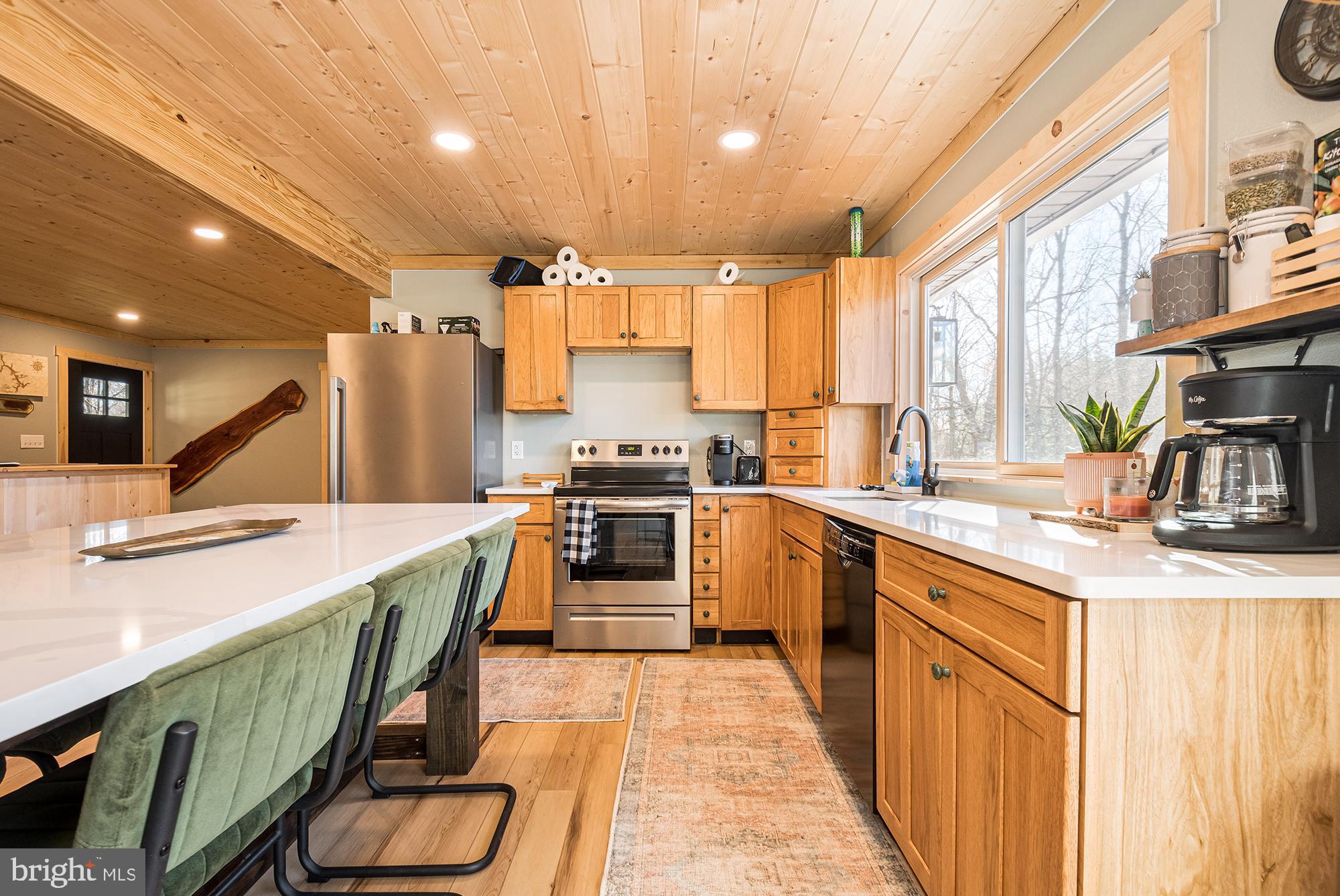 1015 Pysell Road McHenry, MD 21541 - Photo 8 of 56 a kitchen with a sink a counter top space stainless steel appliances and a large window