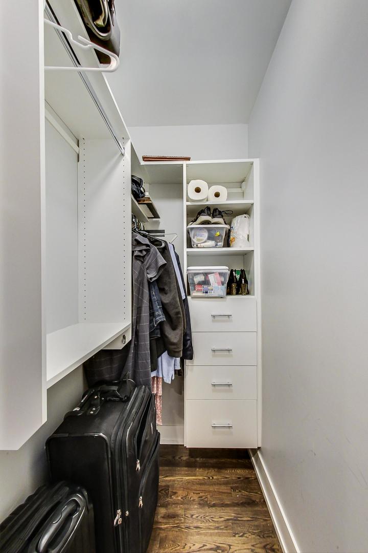 2339 North Drake Avenue Chicago, IL 60647 - Photo 13 of 29 a view of walk in closet with clothes and shoes