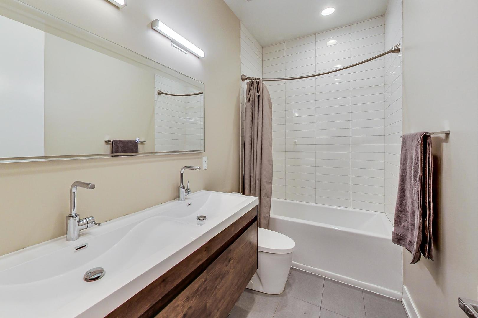 2339 North Drake Avenue Chicago, IL 60647 - Photo 15 of 29 a bathroom with a sink toilet and shower