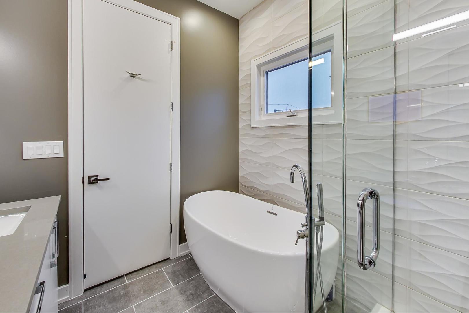 2339 North Drake Avenue Chicago, IL 60647 - Photo 25 of 29 a bathroom with a bathtub and shower