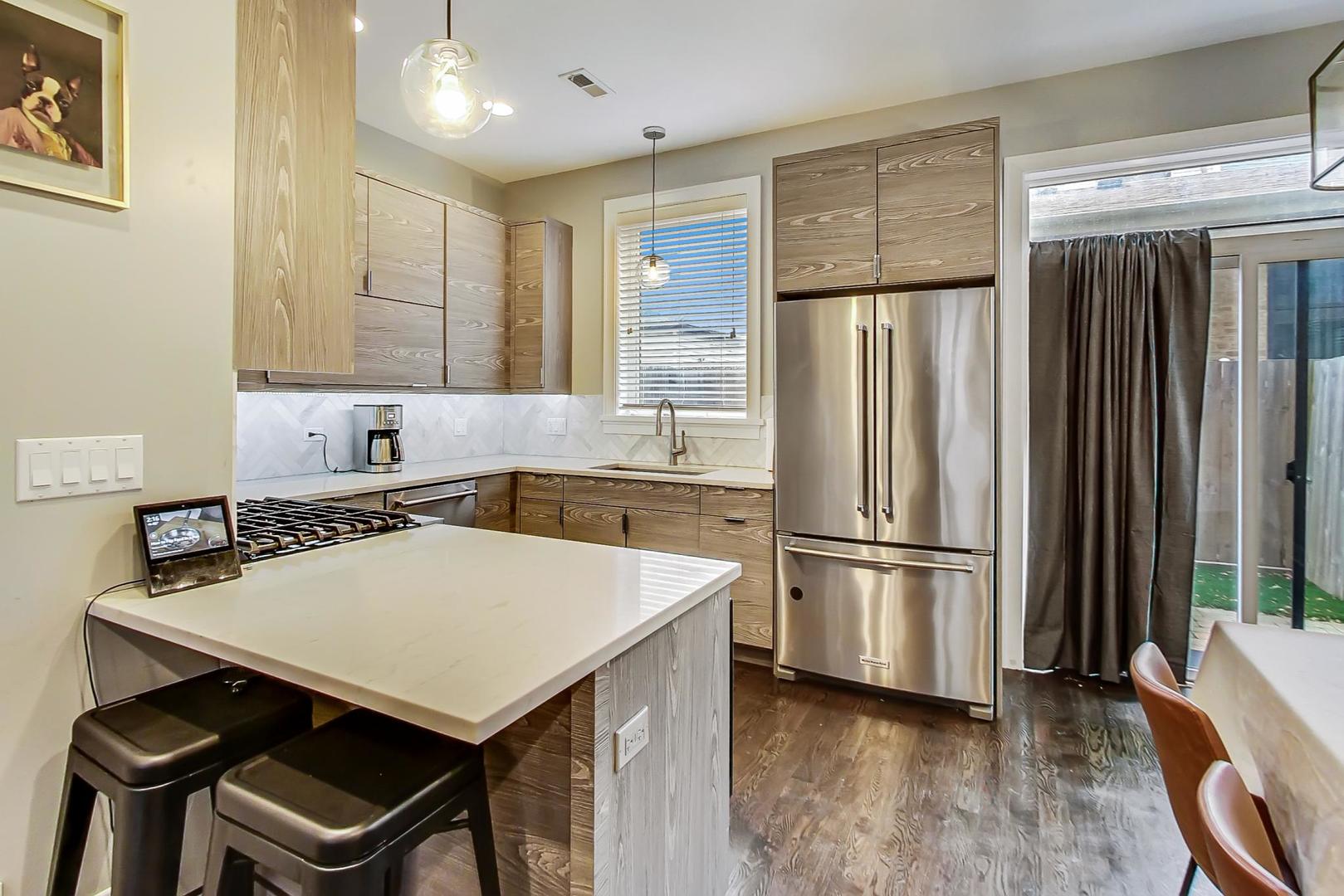 2339 North Drake Avenue Chicago, IL 60647 - Photo 6 of 29 a kitchen with a refrigerator a stove a sink and a refrigerator