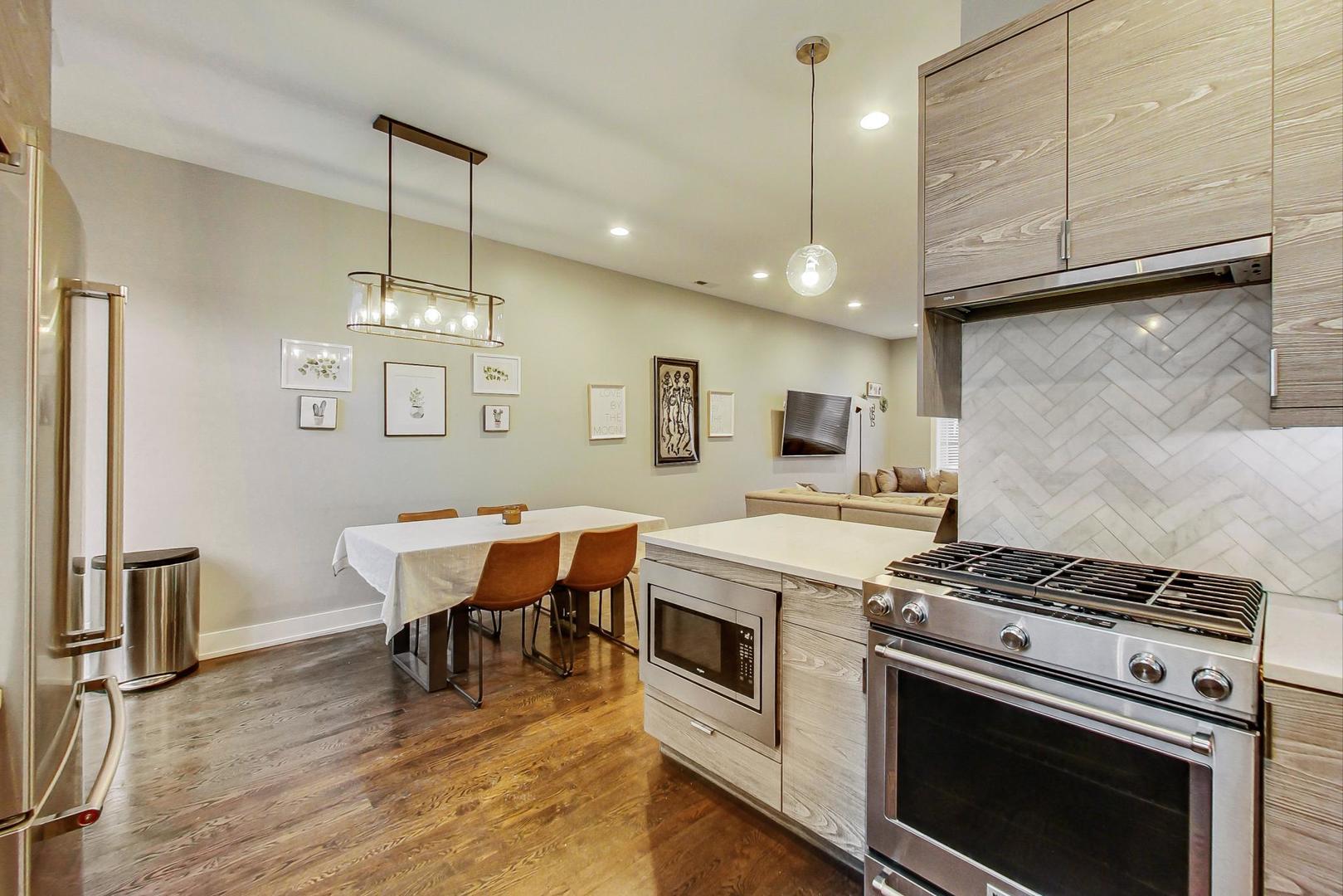 2339 North Drake Avenue Chicago, IL 60647 - Photo 8 of 29 a kitchen with a stove a sink and wooden floor