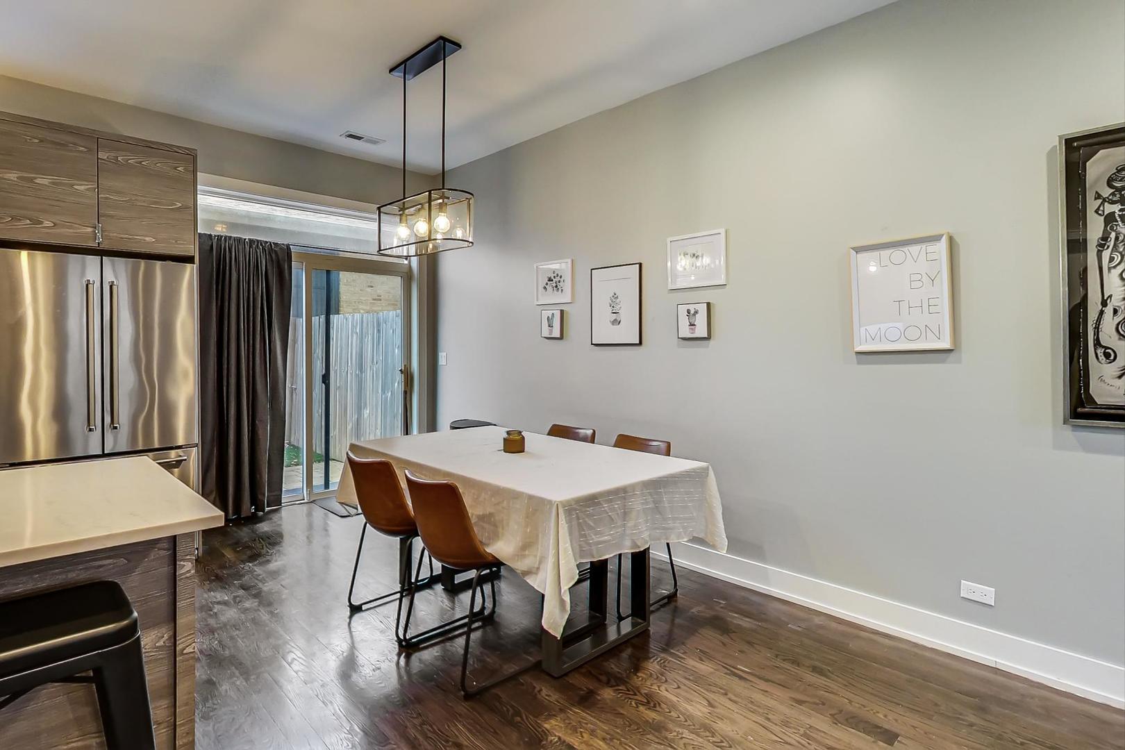 2339 North Drake Avenue Chicago, IL 60647 - Photo 9 of 29 a view of a dining room with furniture window and wooden floor