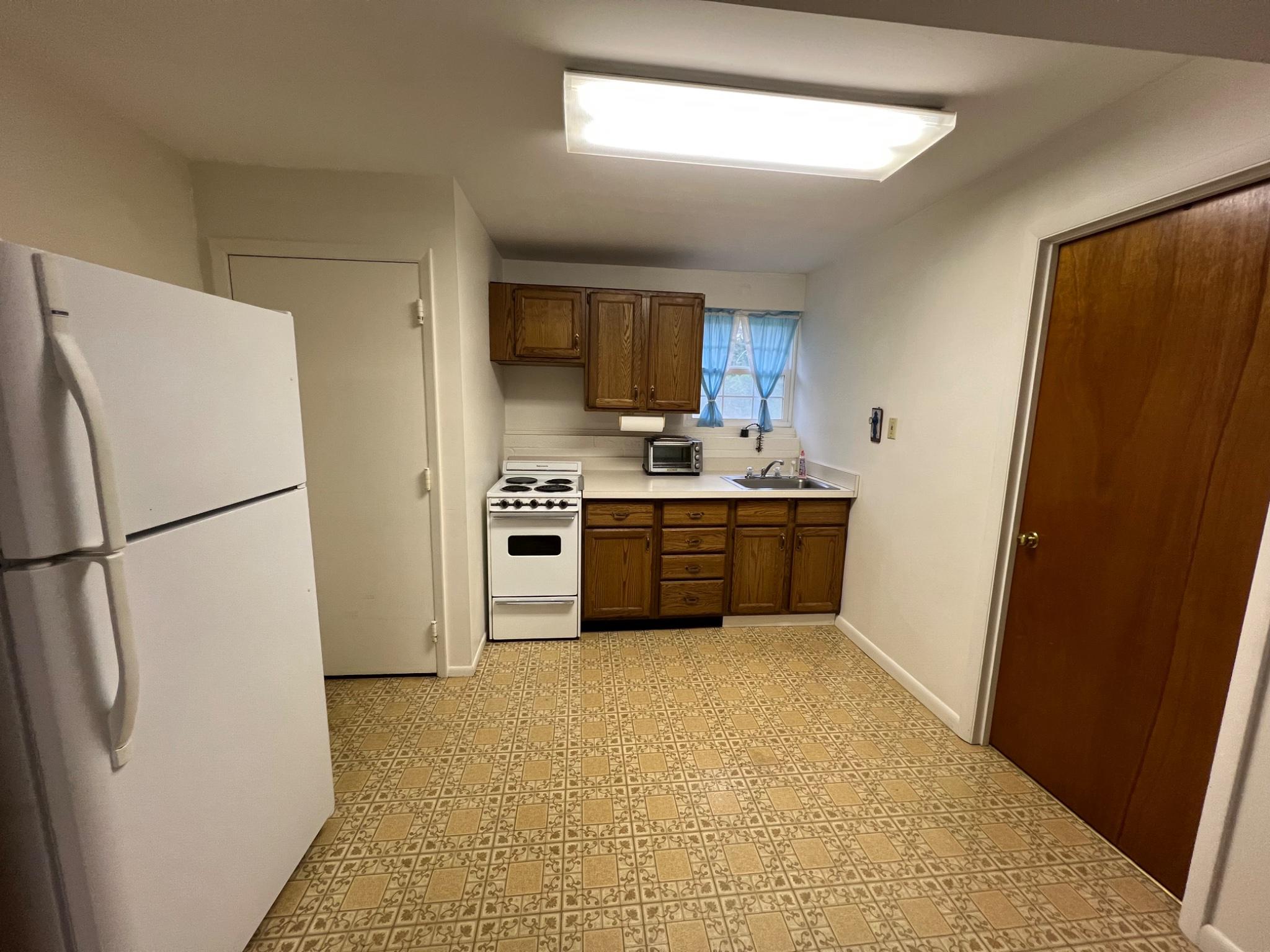 8531 Solomons Island Road North Owings, MD 20736 - Photo 11 of 12 a kitchen with stainless steel appliances a refrigerator and a stove top oven