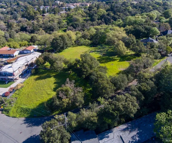 an aerial view of residential houses with outdoor space and swimming pool