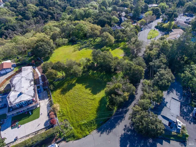 an aerial view of a houses with a yard