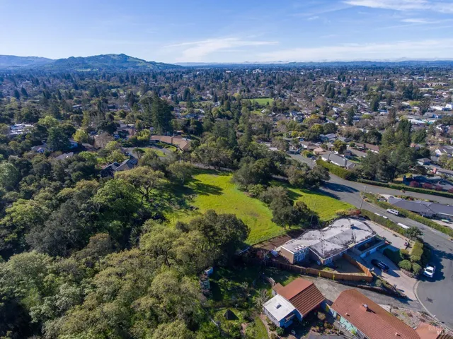 an aerial view of residential houses with outdoor space