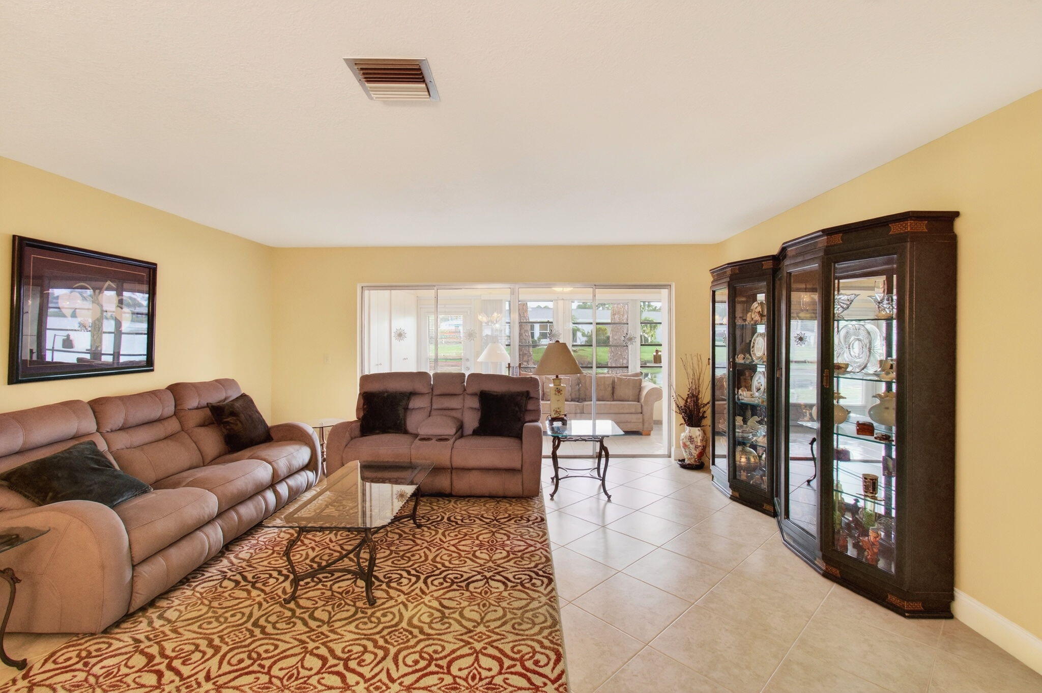 5263 Privet Place, Unit D Delray Beach, FL 33484 - Photo 12 of 60 a living room with furniture and a floor to ceiling window