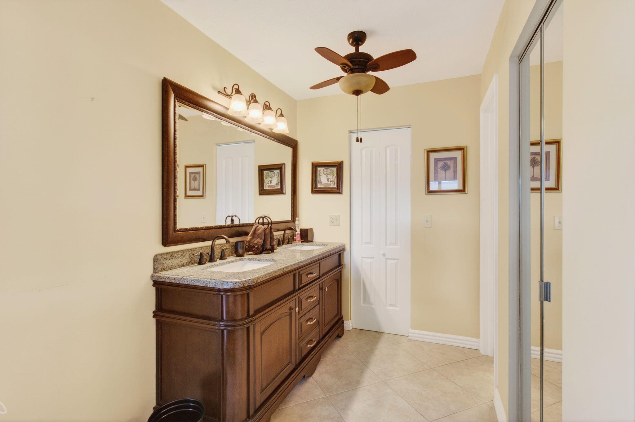 5263 Privet Place, Unit D Delray Beach, FL 33484 - Photo 28 of 60 a bathroom with a sink a mirror and a light fixture