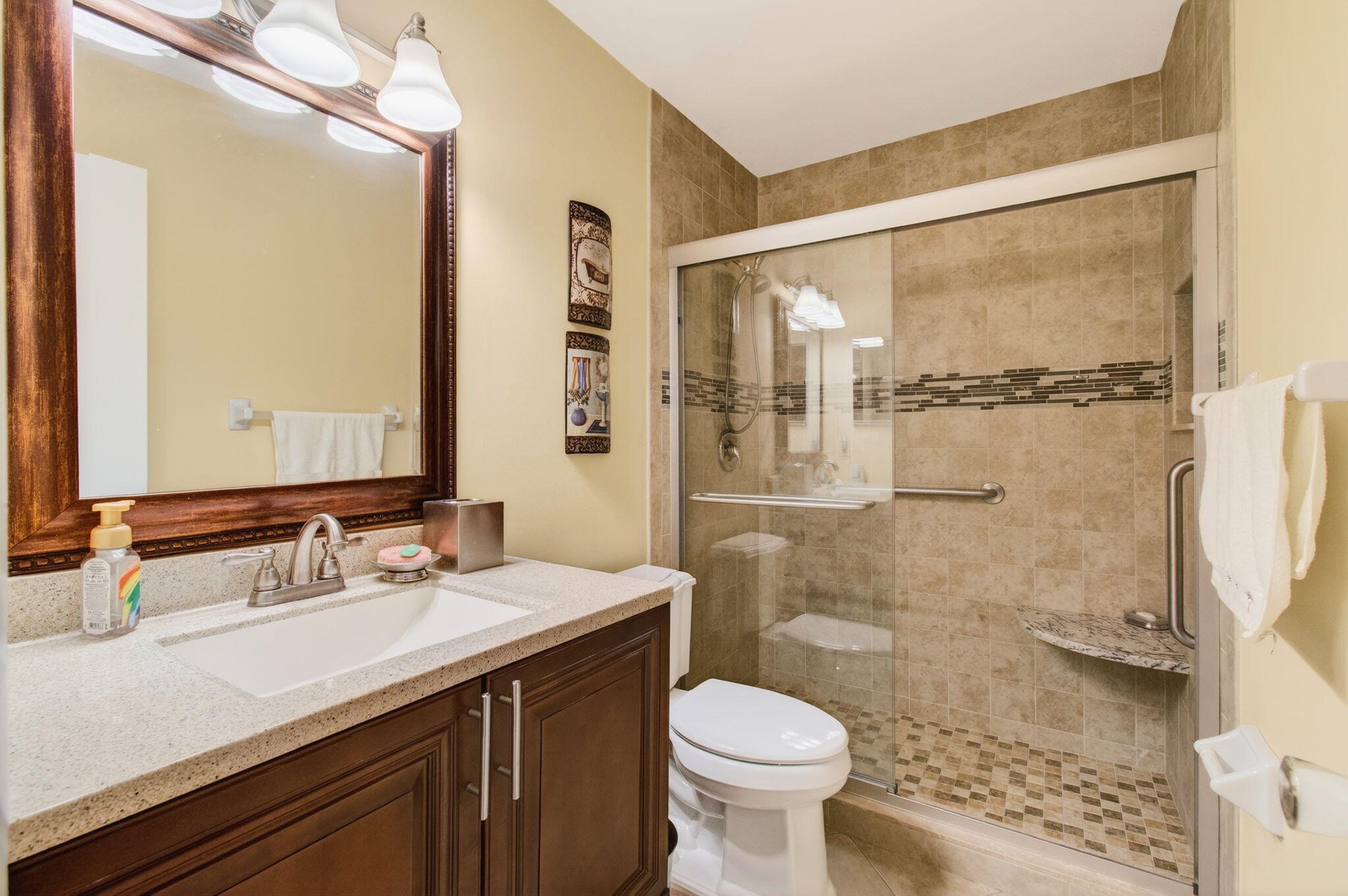 5263 Privet Place, Unit D Delray Beach, FL 33484 - Photo 31 of 60 a bathroom with a sink and a mirror