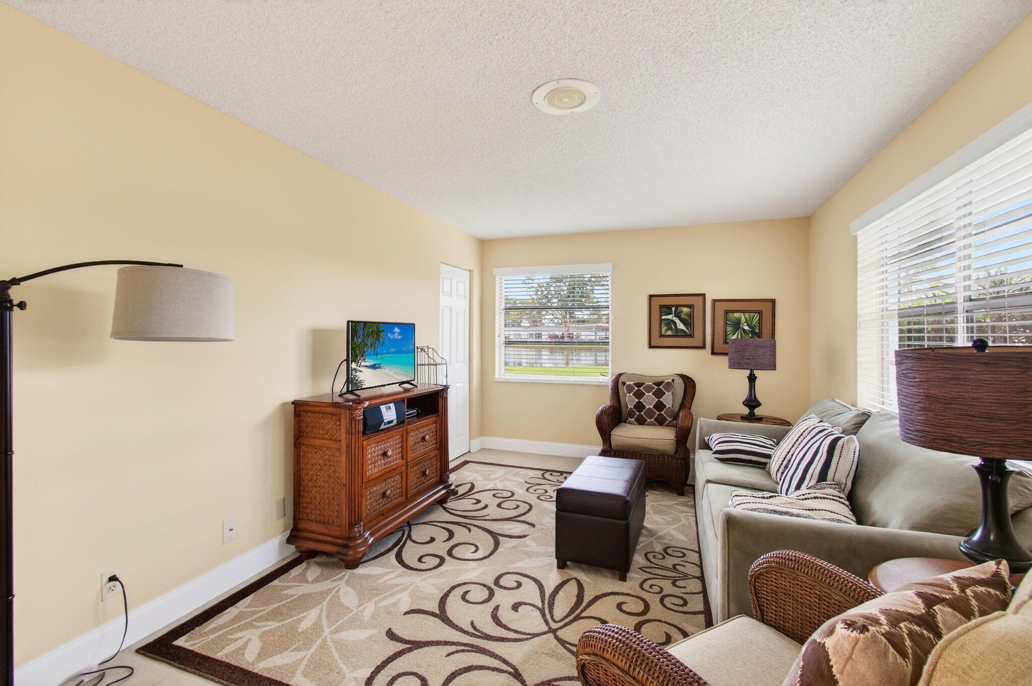 5263 Privet Place, Unit D Delray Beach, FL 33484 - Photo 32 of 60 a living room with furniture and a flat screen tv