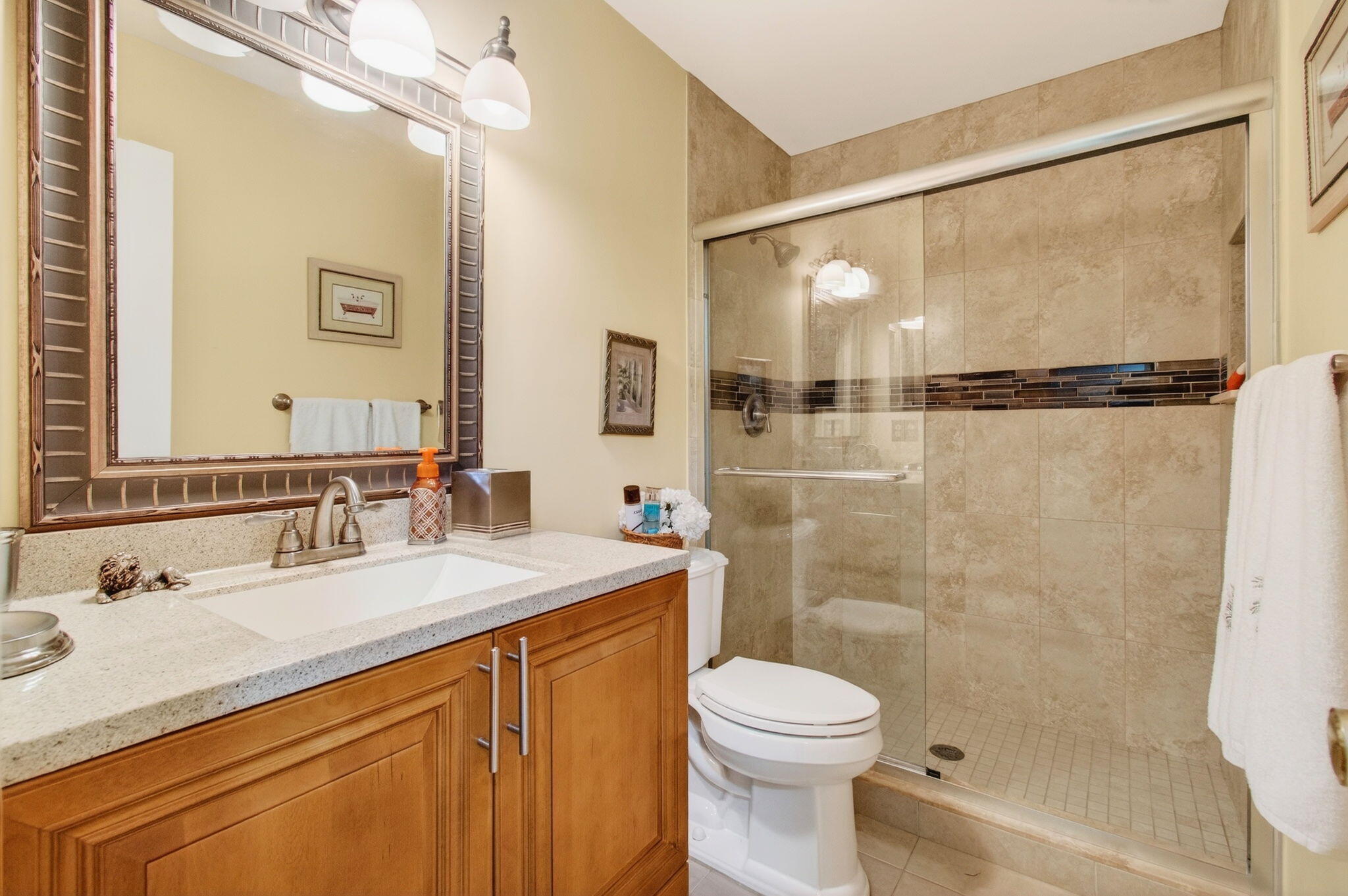 5263 Privet Place, Unit D Delray Beach, FL 33484 - Photo 35 of 60 a bathroom with a sink a toilet and shower