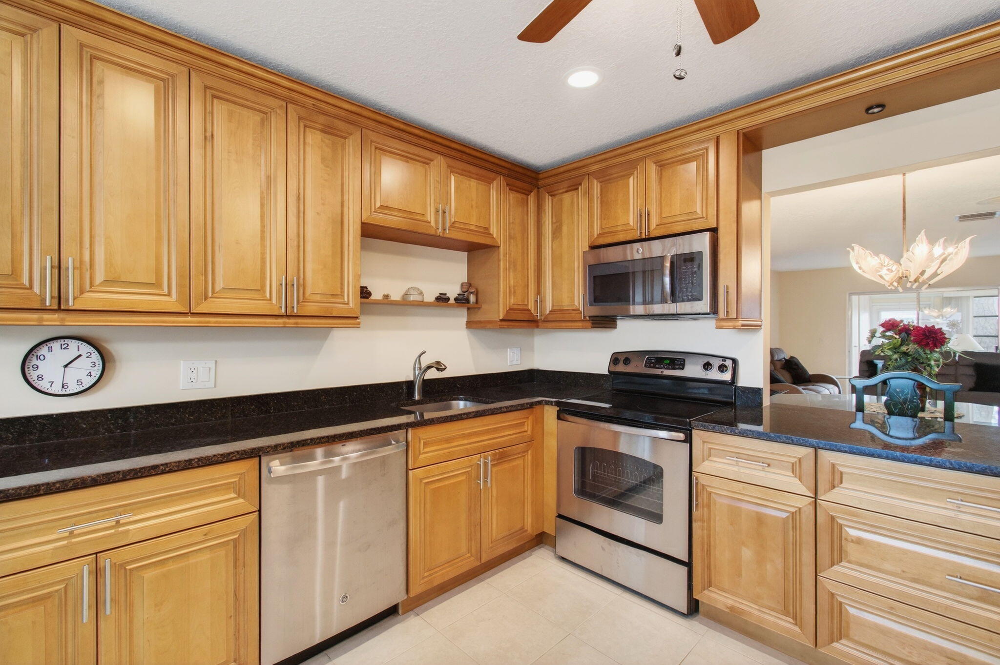5263 Privet Place, Unit D Delray Beach, FL 33484 - Photo 5 of 60 a kitchen with granite countertop cabinets stainless steel appliances and a counter space