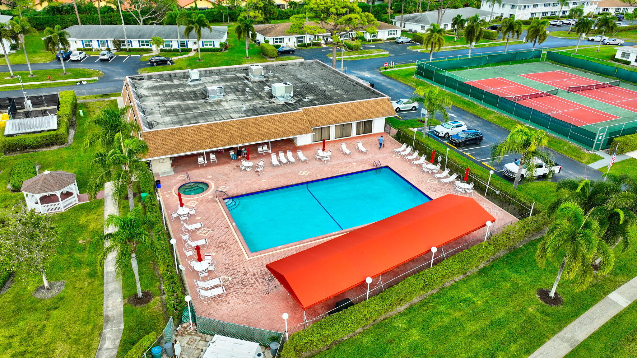 5263 Privet Place, Unit D Delray Beach, FL 33484 - Photo 52 of 60 an aerial view of a tennis ground and a cars park