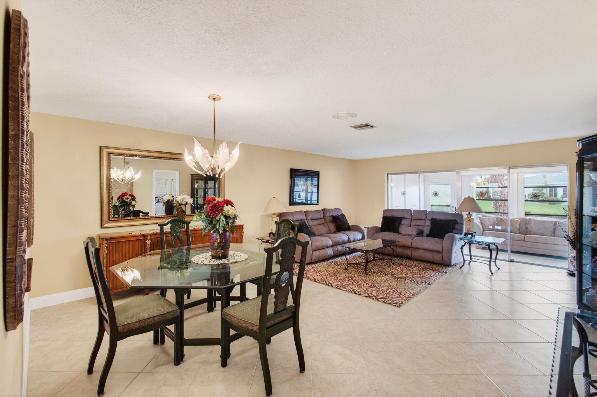 5263 Privet Place, Unit D Delray Beach, FL 33484 - Photo 9 of 60 a view of a dining room with furniture and a chandelier