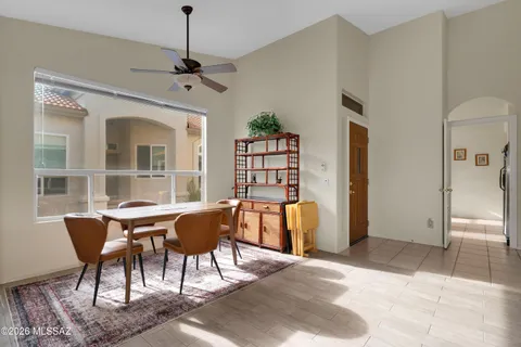 a view of a dining room with furniture and a chandelier