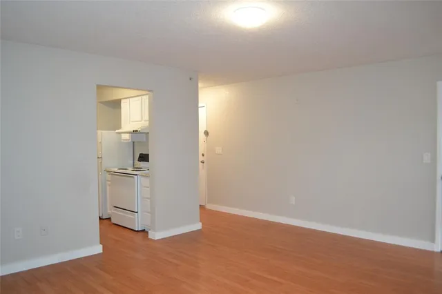 a view of a kitchen with wooden floor