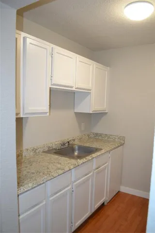 a kitchen with granite countertop white cabinets and a granite counter tops