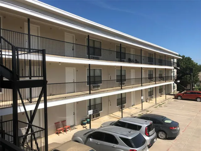 a front view of a building with parking space