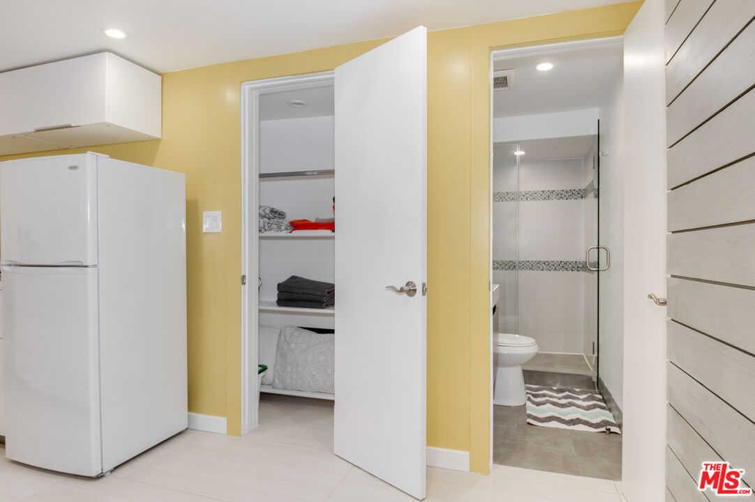 508 North Kings Road, Unit 5 West Hollywood, CA 90048 - Photo 7 of 8 a bathroom with a refrigerator and a sink